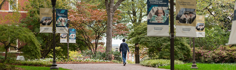 A person walking though campus.