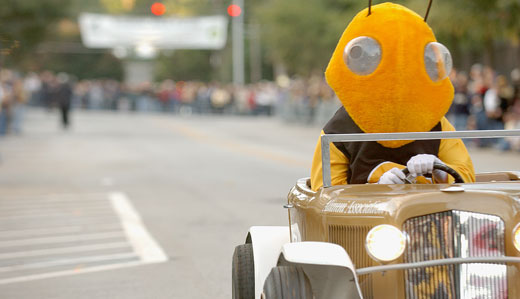 Georgia Tech mascot Buzz drives a miniature version of the other Tech mascot, the Ramblin’ Wreck.