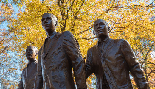 A photo of the statue depicting Ford C. Greene, Ralph A. Long Jr., and Lawrence Williams, the first Black student to enroll at Georgia Tech.  The statue is located in Harrison Square.