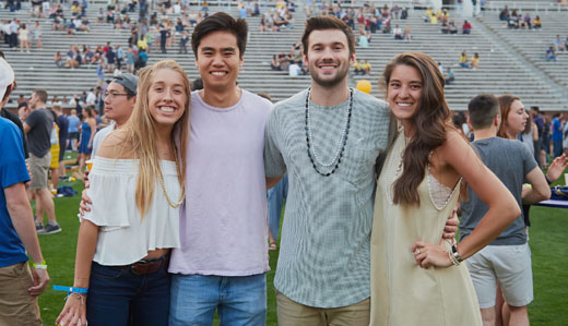 Four undergraduate students at Georgia Tech pose for a photo at the Bobby Dodd Stadium.