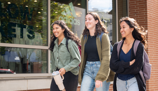 Georgia Tech students walk and laugh together on campus.