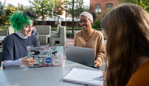 Three undergraduate students work on assignments together on Georgia Tech’s historic Old Campus in Atlanta, Georgia.